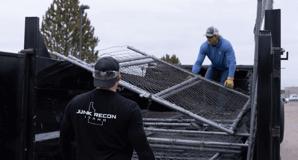 Loading up a trailer with old fences and other junk to remove