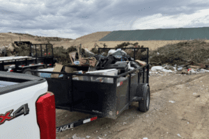 Junk removal truck and trailer full load ready to haul away